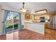Well-lit kitchen and dining area with stainless steel appliances, wooden cabinetry, and patio access at 12535 Forest View St, Broomfield, CO 80020