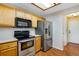 Charming kitchen with wood cabinets, stainless steel appliances, and a bright, airy feel at 12535 Forest View St, Broomfield, CO 80020
