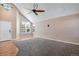 Inviting living room featuring a high ceiling, natural light and a smooth transition from hardwood to plush carpet at 12535 Forest View St, Broomfield, CO 80020