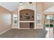 Comfortable living room with a media center, large windows, and seamless access to an outdoor patio at 12535 Forest View St, Broomfield, CO 80020