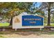 Brandywine Park sign nestled among trees and greenery, creating a welcoming entrance to the park at 12535 Forest View St, Broomfield, CO 80020