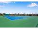 Bright blue and green tennis courts on a sunny day, showcasing recreational amenities at 12535 Forest View St, Broomfield, CO 80020