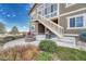 Back of house showing the staircase leading to the second story and a large stone firepit at 2601 Loyd Cir, Parker, CO 80138