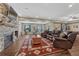 Finished basement area with stone fireplace, seating, and home gym equipment at 2601 Loyd Cir, Parker, CO 80138