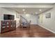 Finished basement area with wood-look flooring, dining table, and TV at 2601 Loyd Cir, Parker, CO 80138