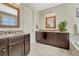 Bathroom featuring double sinks with granite countertops and dark wood cabinets at 2601 Loyd Cir, Parker, CO 80138