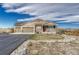 Charming home featuring a three-car garage, a cozy porch, and manicured landscaping on a sunny day at 2601 Loyd Cir, Parker, CO 80138