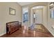 A stylish foyer features hardwood floors, a bench, an area rug, and a view into another room at 2601 Loyd Cir, Parker, CO 80138