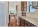 Hallway featuring dark wood floors, leading into an open-concept kitchen and living area at 2601 Loyd Cir, Parker, CO 80138