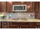 Modern kitchen featuring granite countertops, stainless steel appliances, and stylish tile backsplash at 2601 Loyd Cir, Parker, CO 80138