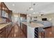 Stylish kitchen featuring stainless steel appliances, hardwood floors, granite counters, and a center island with seating at 2601 Loyd Cir, Parker, CO 80138