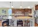 Bright kitchen featuring stainless steel appliances, hardwood floors, granite counters, and a center island with seating at 2601 Loyd Cir, Parker, CO 80138