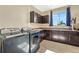 Laundry room featuring a front load washer and dryer, window, sink and storage cabinets at 2601 Loyd Cir, Parker, CO 80138