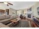Cozy living room featuring a fireplace, hardwood floors, a ceiling fan, and comfortable seating at 2601 Loyd Cir, Parker, CO 80138
