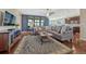 Comfortable living room with hardwood floors, large windows, and a neutral sectional sofa at 2601 Loyd Cir, Parker, CO 80138