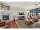 Bright living room with hardwood floors, a fireplace, and an entertainment center under the wall-mounted television at 2601 Loyd Cir, Parker, CO 80138
