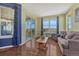 Comfortable living room with large windows offering scenic views and hardwood floors at 2601 Loyd Cir, Parker, CO 80138