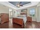 Inviting main bedroom with hardwood floors, tray ceiling, and ensuite bathroom at 2601 Loyd Cir, Parker, CO 80138