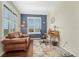 Bright home office with a dark blue accent wall, hardwood floors and a leather loveseat at 2601 Loyd Cir, Parker, CO 80138