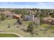 An aerial view of a home in a wooded neighborhood setting featuring mature trees and well-maintained lawns at 7575 E Windlawn Way, Parker, CO 80134