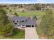 Beautiful two-story home with mature landscaping and a long driveway overlooking a golf course at 7575 E Windlawn Way, Parker, CO 80134