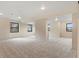 Spacious carpeted basement area featuring natural light from egress windows, offering a versatile living space at 7575 E Windlawn Way, Parker, CO 80134