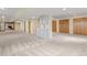Large basement area with plush carpeting, wet bar, and storage closets, perfect for entertaining and organization at 7575 E Windlawn Way, Parker, CO 80134