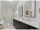 Modern bathroom with a glass-enclosed shower and a dual sink vanity at 7575 E Windlawn Way, Parker, CO 80134