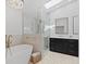 Modern bathroom with a skylight, glass shower, and freestanding tub at 7575 E Windlawn Way, Parker, CO 80134