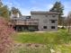 Beautiful view of the back of the house, with its deck and walk out basement and large grassy yard at 7575 E Windlawn Way, Parker, CO 80134