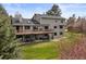 Two-story home showcasing a large deck, covered patio, and spacious backyard, perfect for outdoor living at 7575 E Windlawn Way, Parker, CO 80134