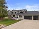Charming home with a well-manicured lawn, mature landscaping, and a three car garage at 7575 E Windlawn Way, Parker, CO 80134