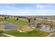 Scenic golf course view featuring mature trees, ponds and meticulously maintained green at 7575 E Windlawn Way, Parker, CO 80134