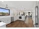 Spacious open-concept kitchen featuring stainless steel appliances, an island, and white cabinets at 7575 E Windlawn Way, Parker, CO 80134