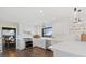 Bright kitchen with white cabinets, stainless steel appliances, and hardwood floors at 7575 E Windlawn Way, Parker, CO 80134
