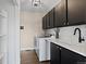 Well-organized laundry room with washer, dryer, sink, and modern cabinets at 7575 E Windlawn Way, Parker, CO 80134