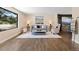 Bright living room featuring hardwood floors, neutral paint, and a large picture window at 7575 E Windlawn Way, Parker, CO 80134