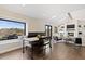 Open living space with dining area, fireplace, and hardwood floors at 7575 E Windlawn Way, Parker, CO 80134