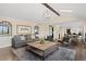 Cozy living room with a large sofa, coffee table, and view to kitchen at 7575 E Windlawn Way, Parker, CO 80134
