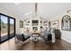 Inviting living room with a fireplace, built-in shelving, and large windows at 7575 E Windlawn Way, Parker, CO 80134