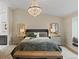 Serene bedroom featuring a crystal chandelier, and natural light at 7575 E Windlawn Way, Parker, CO 80134