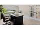 Another view of the home office with a desk, chair, and bright window at 7575 E Windlawn Way, Parker, CO 80134