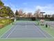 Well-maintained tennis courts surrounded by manicured landscaping and mature trees at 7575 E Windlawn Way, Parker, CO 80134