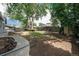 Spacious backyard featuring mature trees and a fire pit at 362 Brigitte Dr, Northglenn, CO 80260