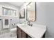 Bathroom with modern vanity, a large mirror, and neutral color scheme at 362 Brigitte Dr, Northglenn, CO 80260