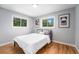 Bedroom with hardwood floors, grey walls, and natural light from two windows at 362 Brigitte Dr, Northglenn, CO 80260