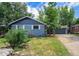 Charming blue brick home with a well-manicured front yard and cozy front porch at 362 Brigitte Dr, Northglenn, CO 80260
