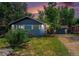 Charming single-story home featuring a lush green lawn, mature trees, and a private driveway with a detached garage at 362 Brigitte Dr, Northglenn, CO 80260