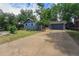 Inviting single-story home with a well-manicured lawn, mature trees, and a detached garage accessible via a private driveway at 362 Brigitte Dr, Northglenn, CO 80260