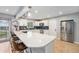 Modern kitchen with white cabinets, stainless steel appliances, and a large island at 362 Brigitte Dr, Northglenn, CO 80260